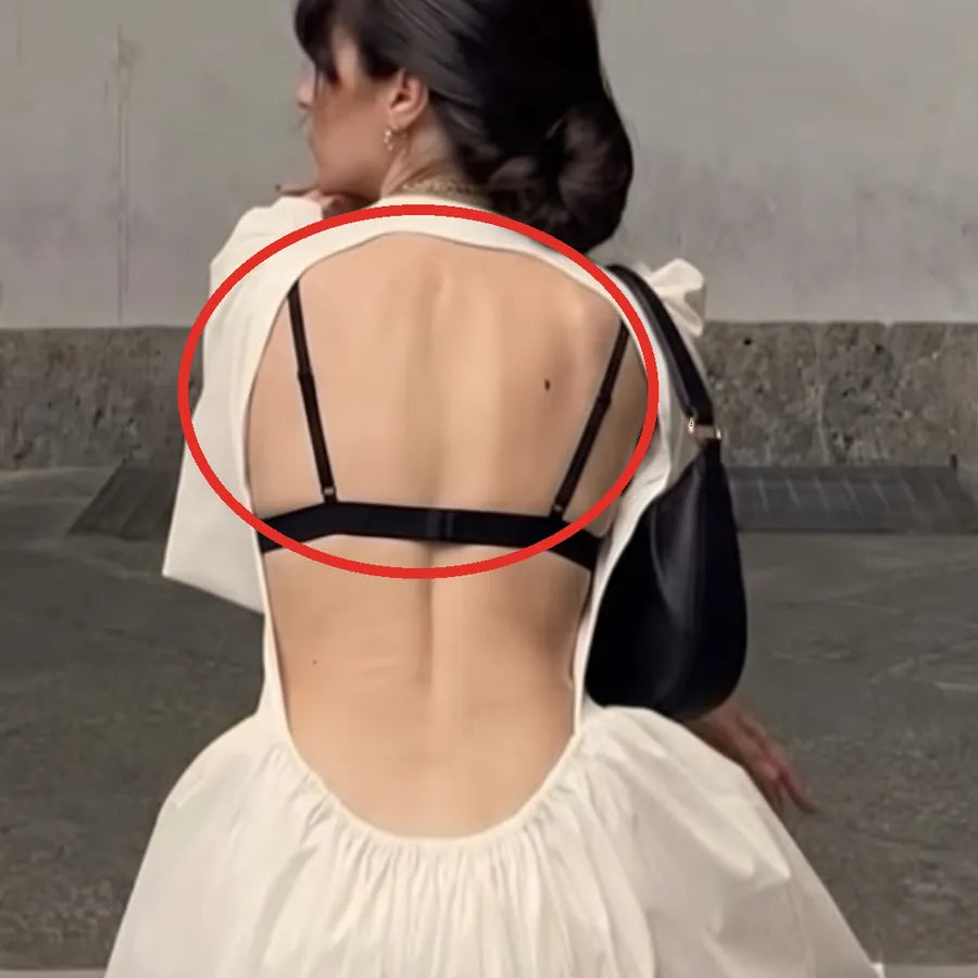 Black bra band showing in an open-back dress