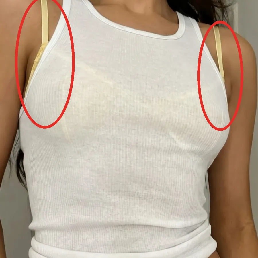 Yellow bra straps showing under a white tank top