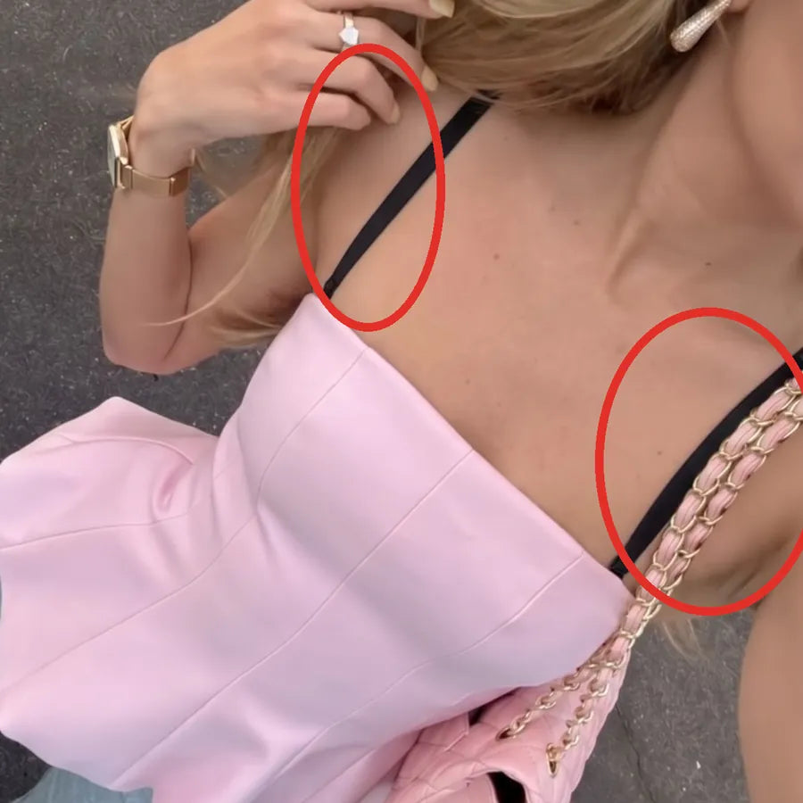 Black bra straps showing with a pink strapless top