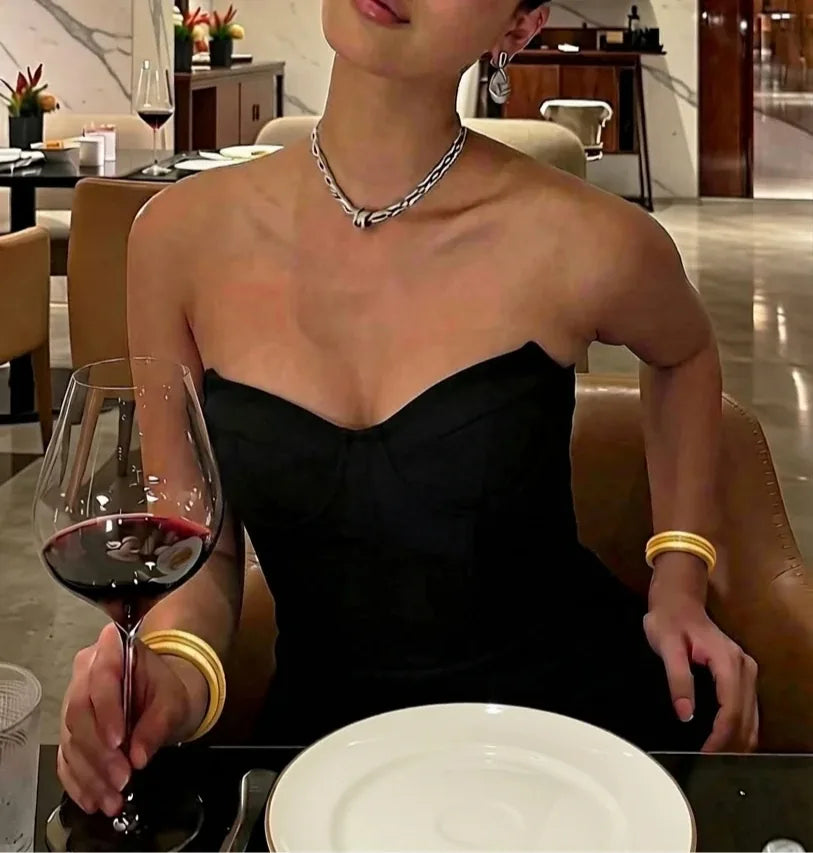 Black strapless dress with full cleavage at a dinner date