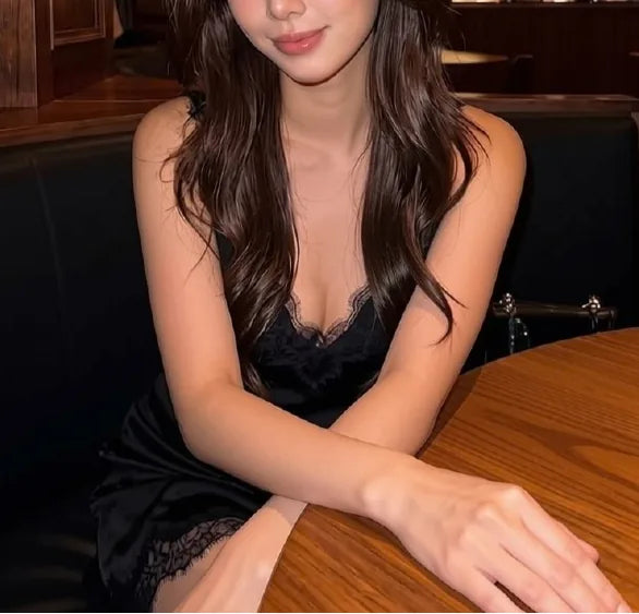 Black lace slip dress with cleavage at a bar